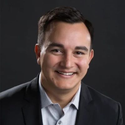 a headshot of a man in business suit